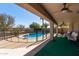 Covered patio with seating area overlooking a private fenced pool at 17705 N Vera Cruz Ave, Maricopa, AZ 85139