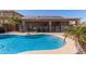 Gorgeous swimming pool with safety fence, outdoor living area, and solar panels for energy efficiency at 17705 N Vera Cruz Ave, Maricopa, AZ 85139