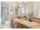 Bathroom with double sinks, a large mirror, and a tile countertop at 17893 N 93Rd St, Scottsdale, AZ 85255