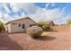 This low-maintenance backyard with desert landscaping offers a private outdoor retreat at 18004 W Palo Verde Ave, Waddell, AZ 85355