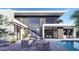 Stylish backyard with a pool, comfortable outdoor seating, and large windows showcasing the home's interior at 1830 E Palmaire Ave, Phoenix, AZ 85020