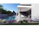 Pool area with a modern outdoor kitchen, stylish seating, and views of the contemporary home and landscaping at 1830 E Palmaire Ave, Phoenix, AZ 85020