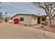 Exterior view of a single story home with desert landscaping and a large shade tree at 19481 N Star Ridge Dr, Sun City West, AZ 85375