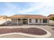 A well kept backyard with a covered patio and desert landscaping at 19824 N 94Th Ln, Peoria, AZ 85382