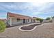 Well maintained backyard with desert landscaping, and a covered patio at 19824 N 94Th Ln, Peoria, AZ 85382