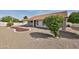 A well kept backyard with a covered patio and desert landscaping at 19824 N 94Th Ln, Peoria, AZ 85382