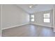 A spacious bedroom with light wood flooring, neutral walls, and ample natural light at 19824 N 94Th Ln, Peoria, AZ 85382