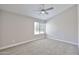 Large bedroom with a window and neutral colored walls and carpet at 19824 N 94Th Ln, Peoria, AZ 85382