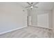 Neutral-toned bedroom featuring carpet, ceiling fan, and double door closet at 19824 N 94Th Ln, Peoria, AZ 85382