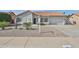 Charming single-story home with a red tile roof, desert landscaping, and an attached two-car garage at 19824 N 94Th Ln, Peoria, AZ 85382