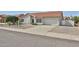 Charming single-story home featuring a well-manicured front yard and two car garage at 19824 N 94Th Ln, Peoria, AZ 85382