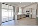 Open kitchen showcasing gray cabinets, stainless appliances, and sliding glass doors to patio at 19824 N 94Th Ln, Peoria, AZ 85382