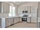 Stylish kitchen features gray cabinets, stainless appliances, and bright natural light at 19824 N 94Th Ln, Peoria, AZ 85382