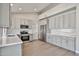 Modern kitchen with gray cabinets, stainless steel appliances, and sleek countertops at 19824 N 94Th Ln, Peoria, AZ 85382