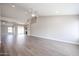 Living room with hardwood style flooring, white walls, and high ceilings at 19824 N 94Th Ln, Peoria, AZ 85382