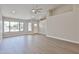 Inviting living room with neutral walls, wood-look floors, and large bright windows at 19824 N 94Th Ln, Peoria, AZ 85382