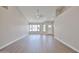 Bright and airy living room with light wood flooring and modern ceiling fan at 19824 N 94Th Ln, Peoria, AZ 85382