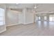 Open concept living room featuring luxury vinyl floors, tall ceilings, and white walls at 19824 N 94Th Ln, Peoria, AZ 85382