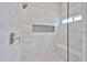 Modern walk-in shower featuring white subway tile and built-in shower niche at 19824 N 94Th Ln, Peoria, AZ 85382