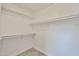 Walk-in closet with white walls and built-in white shelves for storage at 19824 N 94Th Ln, Peoria, AZ 85382