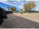 Spacious backyard featuring gravel landscaping, mature trees, and a cozy fire pit area at 245 S 56Th St # 112, Mesa, AZ 85206