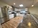 Updated kitchen featuring stainless steel appliances, farmhouse sink, tile backsplash, and breakfast bar at 245 S 56Th St # 112, Mesa, AZ 85206