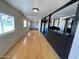 Spacious living room with light wood floors, a bar, and ample natural light at 245 S 56Th St # 112, Mesa, AZ 85206