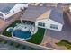 An aerial shot captures a backyard haven with a pool, patio seating, lush turf, and meticulous landscaping at 2535 E Thornton Ct, Gilbert, AZ 85297