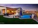Stunning backyard with a sparkling pool, fire pit, and ample seating for outdoor relaxation and entertainment at 2535 E Thornton Ct, Gilbert, AZ 85297