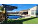 Beautiful backyard featuring a pool with pergola and fire pit with ample seating for entertainment at 2535 E Thornton Ct, Gilbert, AZ 85297