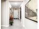 Bright hallway with neutral walls, tiled floor, and decorative art leading to the front door at 2535 E Thornton Ct, Gilbert, AZ 85297