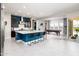 Modern kitchen with large island and ample seating, flowing into an adjacent game room at 2535 E Thornton Ct, Gilbert, AZ 85297