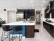 Bright kitchen with a large island featuring seating, a stainless steel refrigerator, and dark wood cabinets at 2535 E Thornton Ct, Gilbert, AZ 85297