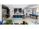 Open-concept kitchen with large island, stainless steel appliances, and adjacent game room with a pool table at 2535 E Thornton Ct, Gilbert, AZ 85297