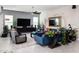 Bright living room with tile floors, sleek furniture, and a large TV for relaxing entertainment at 2535 E Thornton Ct, Gilbert, AZ 85297