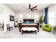 A spacious bedroom features a king bed, ceiling fan, sitting area, and view of the en-suite bathroom at 2535 E Thornton Ct, Gilbert, AZ 85297