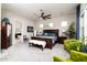 The large main bedroom features a king bed, accent chairs, a ceiling fan, and an en-suite bathroom at 2535 E Thornton Ct, Gilbert, AZ 85297