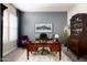 A stylish home office features a spacious desk, elegant furnishings, and soft, neutral décor at 2535 E Thornton Ct, Gilbert, AZ 85297