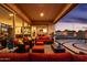 Inviting covered patio featuring stylish outdoor furniture and views of the meticulously landscaped yard at 2535 E Thornton Ct, Gilbert, AZ 85297