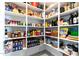Organized pantry with stocked shelves filled with a variety of food and drink items for convenient storage at 2535 E Thornton Ct, Gilbert, AZ 85297