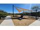 Community playground featuring a slide, swings, and covered seating area for outdoor enjoyment at 2535 E Thornton Ct, Gilbert, AZ 85297