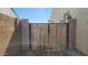 Wood gate set in a block wall provides side yard access at 2535 E Thornton Ct, Gilbert, AZ 85297
