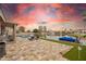 Spacious backyard with a pool, lake view, and outdoor kitchen setup, perfect for entertaining and enjoying the outdoors at 3121 N Meadow Dr, Avondale, AZ 85392