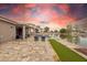 Expansive backyard featuring a pool, scenic lake views, lush green lawn, and an outdoor dining area for relaxation at 3121 N Meadow Dr, Avondale, AZ 85392