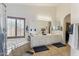 Bright bathroom featuring a soaking tub, plantation shutters, dual sinks, and a large mirror at 3121 N Meadow Dr, Avondale, AZ 85392