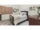 Comfortable bedroom with a wood-trimmed sleigh bed, soft throw blanket, and plantation shutters at 3121 N Meadow Dr, Avondale, AZ 85392
