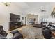 Spacious living room with a fireplace, a large entertainment center, and plush seating, perfect for relaxation at 3121 N Meadow Dr, Avondale, AZ 85392