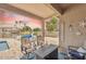 Relaxing covered patio with outdoor seating, offering picturesque views of the pool and a tranquil lake setting at 3121 N Meadow Dr, Avondale, AZ 85392