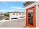 Balcony view of a modern townhome with a red door and a bright blue sky at 3150 E Beardsley Rd # 1038, Phoenix, AZ 85050