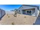 Spacious backyard with a covered patio and low-maintenance gravel landscaping at 3353 W Shanley Ave, Apache Junction, AZ 85120